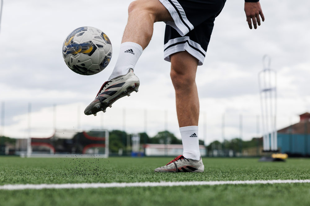 A close-up of a footballer juggling the ball with their foot