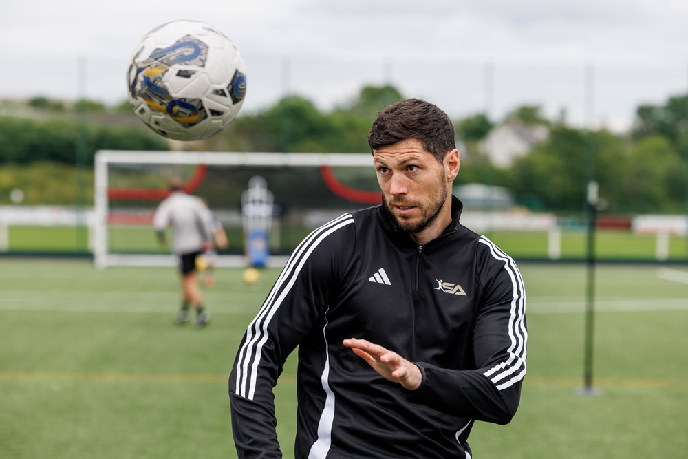 Scott McKenna heading a football.